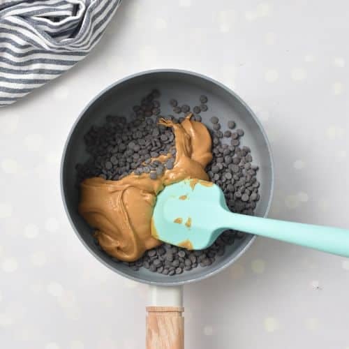 Chocolate chips and peanut butter in a saucepan.