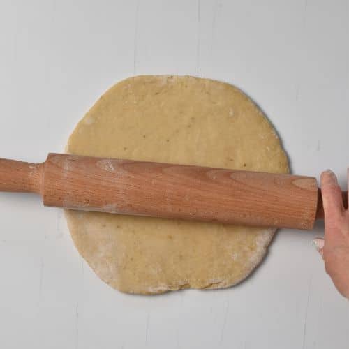 Rolling the 4-Ingredient Chewy Banana Cookies with a rolling pin.