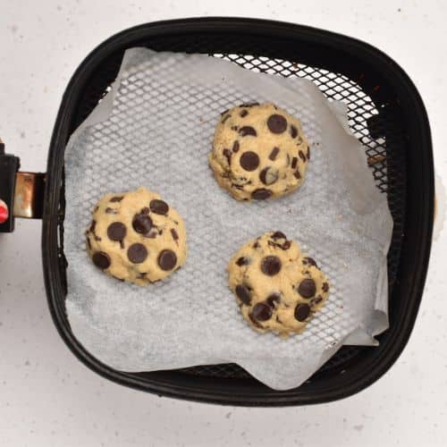 Air fryer Chocolate Chip Cookies ready to bake in an air fryer basket.