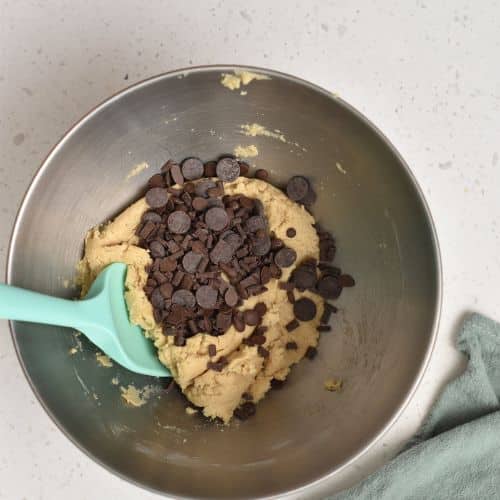 Adding chocolate chips to the Air fryer Chocolate Chip Cookie dough.