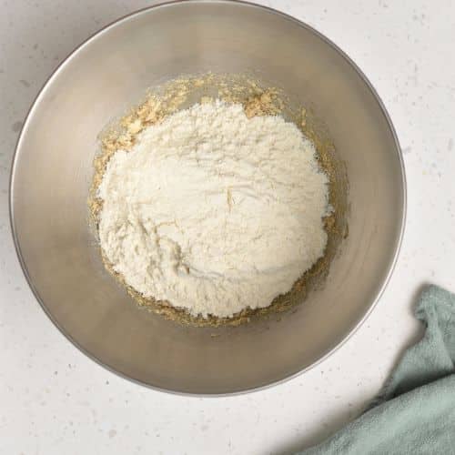 Adding flour to the Air fryer Chocolate Chip Cookie mixture.