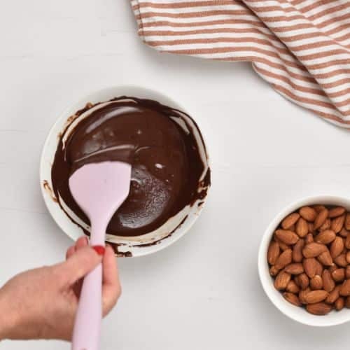 Mixing melted chocolate for the Almond Clusters.