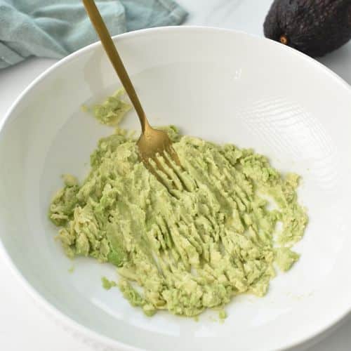 Mashed avocado in a bowl.