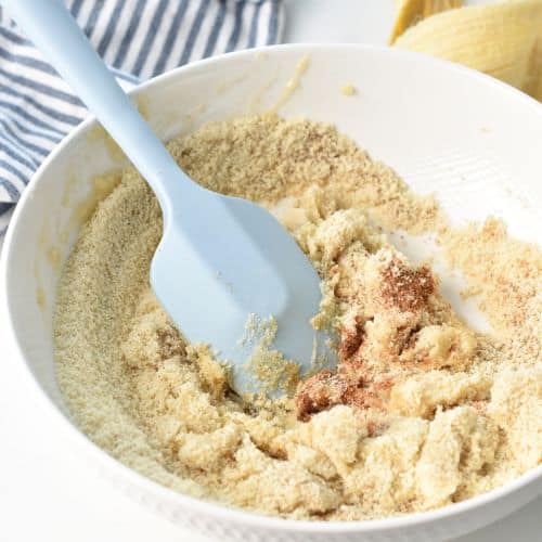 Mixing Banana Bite ingredients in a mixing bowl.