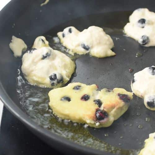 Blueberry Fritters cooking in oil.