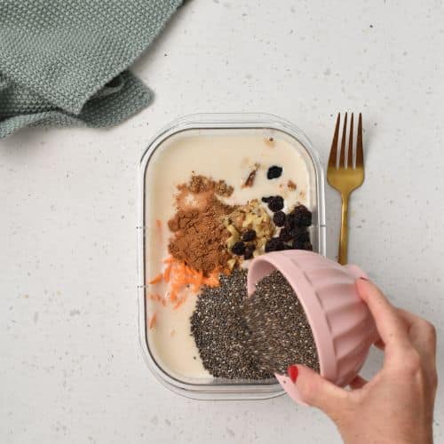 Combining the Carrot Cake Chia Pudding ingredients in a bowl.