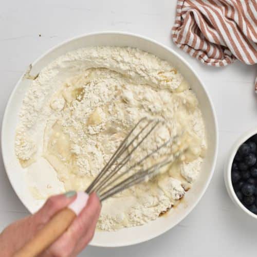 Mixing the Healthy Blueberry Pancake batter with a whisk.