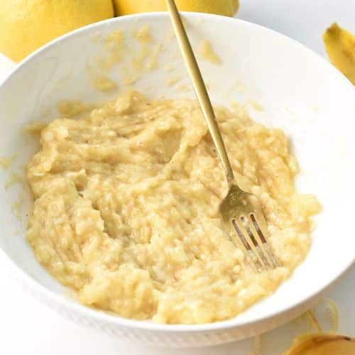 Mashed banana in a mixing bowl.