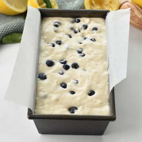 Lemon Blueberry Bread batter in a loaf pan ready to bake.