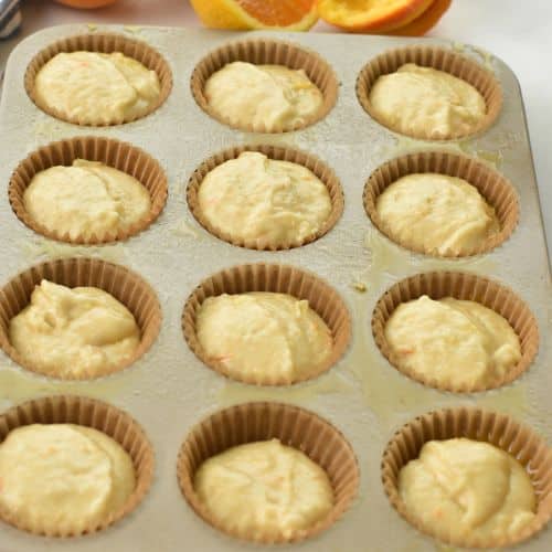 Orange Muffins in a muffin tin ready to bake.