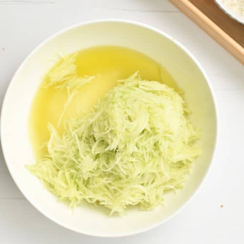 Shredded zucchini in a bowl.